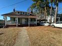 Inviting two-story home featuring a quaint front porch and classic architectural details at 302 N 12Th St, Erwin, NC 28339