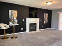 Living room boasts dark walls, a white fireplace, and modern décor, perfect for entertaining at 3609 Cold Harbour Dr, Raleigh, NC 27610