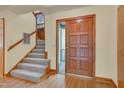 Bright foyer with hardwood floors, staircase, and a wood front door at 3622 Moonlight Dr, Chapel Hill, NC 27516