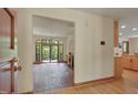 Open living room layout with brick flooring and a large glass door leading to the outdoor deck at 3622 Moonlight Dr, Chapel Hill, NC 27516