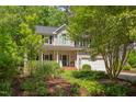 Charming two-story home with manicured landscaping, inviting front porch, and attached two car garage at 401 Robert Hunt Dr, Carrboro, NC 27510