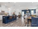 Open-concept kitchen showcasing a large island, modern appliances, and seamless flow into the living space at 420 Longleaf Glen Ln, Zebulon, NC 27597