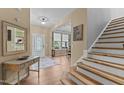 Spacious foyer with hardwood floors, staircase, and decorative accents at 513 Heswall Ct, Rolesville, NC 27571