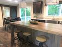 Modern kitchen with spacious island, stainless steel sink, and adjacent dining area at 550 Saplin Branch Rd, Timberlake, NC 27583