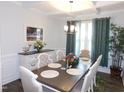 Elegant dining room boasts a decorative chandelier, a stylish buffet, and seating for six at 633 Longstanton Ave, Zebulon, NC 27597