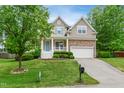 Charming two-story home featuring blue shutters, a covered porch, a stone accent, and a driveway at 704 Valleywater St, Fuquay Varina, NC 27526