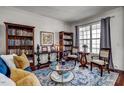 Cozy living room with a large window, comfortable seating, and built-in bookcases at 704 Valleywater St, Fuquay Varina, NC 27526