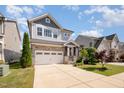 Attractive two-story home featuring a well-kept lawn, stone accents, and an attached two-car garage at 79 Tarwick Ave, Chapel Hill, NC 27516
