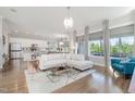 Bright living room showcasing an open floor plan with hardwood floors and large windows at 79 Tarwick Ave, Chapel Hill, NC 27516