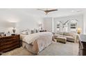 Cozy bedroom featuring a comfortable bed, seating area, and soft natural lighting from the window at 810 Maple Berry Ln # 104, Raleigh, NC 27607