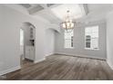 Dining room with decorative chandelier, coffered ceiling and hardwood floors at 95 Black Walnut Dr # 191, Garner, NC 27529