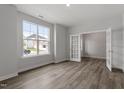 Bright living room with hardwood floors, large windows, and a glass paneled door at 95 Black Walnut Dr # 191, Garner, NC 27529