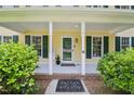 Charming covered porch with a welcome mat, decorative plant, and house number at 106 Shady Point Ct, Durham, NC 27713