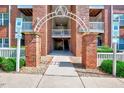 Entrance to apartment building with brick pillars and accessible parking signs at 107 Sturbridge Dr, Clayton, NC 27520