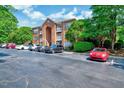 Exterior shot of brick apartment building showing parking and some green space at 107 Sturbridge Dr, Clayton, NC 27520