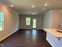 Bright, airy living room featuring dark floors, neutral walls and ample natural light at 1080 River Glade Ct # 17, Graham, NC 27253