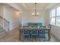 Elegant dining room featuring a wood table with blue chairs and coffered ceilings at 1112 Prominence Dr, Durham, NC 27712