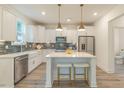 Modern kitchen with white cabinets, stainless steel appliances, and a stylish island with seating at 1112 Prominence Dr, Durham, NC 27712