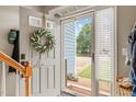 View through open front door with wreath, showing an entryway with a glimpse of the landscaped front yard at 112 Nelson Ln, Clayton, NC 27527