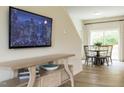 Living room area with hardwood floors, a media console, a TV, and a dining area at 112 Sagamore Avenue, Angier, NC 27501
