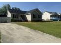 A cute house with a basketball hoop and long driveway in a sunny neighborhood at 118 Hawthorn Dr, Clayton, NC 27520