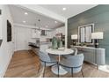 Charming dining area featuring an open floor plan with a view of the modern kitchen and stylish decor at 1242 Coach Station Aly # 101, Raleigh, NC 27601