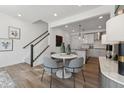 Stylish dining area with hardwood floors, modern lighting, and an open view of the kitchen at 1242 Coach Station Aly # 101, Raleigh, NC 27601