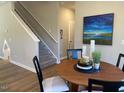 Cozy dining area with a round table, stylish chairs, and a picturesque painting, creating an inviting atmosphere at 128 Sagamore Avenue, Angier, NC 27501