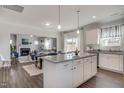 Open-concept kitchen with granite island, white cabinets, flowing seamlessly into dining and living area at 129 Sagamore Ave., Angier, NC 27501