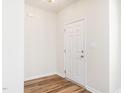 Bright foyer featuring wood-look flooring and a white front door at 1307 Montreux Ct, Mebane, NC 27302