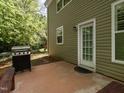Outdoor patio with grill, perfect for entertaining, and greenery surrounding at 1307 Montreux Ct, Mebane, NC 27302