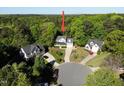 Aerial view of a gray house, nestled in a cul-de-sac, surrounded by lush green trees at 141 Clay Ridge Way, Holly Springs, NC 27540