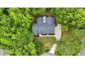 An aerial view of a beautiful single-Gathering house nestled among mature trees, with a private backyard at 146 Bennett Pl, Clayton, NC 27527