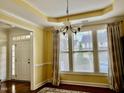 Bright living room with hardwood floors, transom windows, and stylish curtains at 1549 Lily Creek Dr, Cary, NC 27518