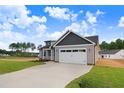 Lovely new construction home with an attached garage and driveway leading up to it at 157 Gumtop Dr, Zebulon, NC 27597