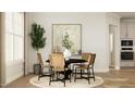Sunlit dining area featuring modern chairs around a round table with stylish decor and hardwood flooring at 1601 Goldfinch Perch Ln, Knightdale, NC 27545
