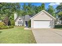 A well-maintained single-Gathering home with an attached garage and a neat front yard at 205 Hornholly Way, Holly Springs, NC 27540
