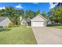 Traditional home featuring a well-maintained lawn, attached garage and inviting curb appeal at 205 Hornholly Way, Holly Springs, NC 27540