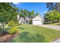 Charming one-story home with a well-manicured lawn and traditional architectural details at 205 Hornholly Way, Holly Springs, NC 27540