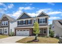 Attractive two-story home with a brick base and a well-groomed front yard at 2100 Curry Meadow Way, Durham, NC 27703