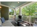 Relaxing front porch with outdoor seating and a fire pit, offering a view of the landscaped front yard at 2121 Karns Pl, Raleigh, NC 27614