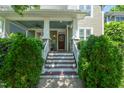 Inviting front porch with white columns, a ceiling fan, and a decorative paw print on the front door at 2121 Karns Pl, Raleigh, NC 27614
