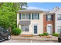 Charming townhome featuring a classic yellow facade with green shutters and a well-manicured front yard at 216 Climbing Ivy Ct, Cary, NC 27511