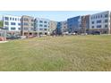 Modern apartment complex with brick and blue siding surrounded by a green lawn at 2418 Gathering Square Ct, Fuquay Varina, NC 27526