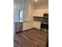 Modern kitchen featuring white cabinets, stainless steel appliances, and granite countertops at 2418 Gathering Square Ct, Fuquay Varina, NC 27526