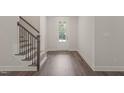 Bright foyer with luxury vinyl plank flooring and a staircase provides a welcoming entrance at 260 Pilot Ridge Rd, Zebulon, NC 27597