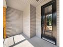Covered front porch featuring a black front door and plenty of sunlight at 260 Pilot Ridge Rd, Zebulon, NC 27597