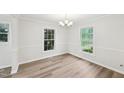 Bright dining area with hardwood floors, windows and elegant chandelier at 2606 Newquay St, Durham, NC 27705