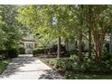 Charming home with a long driveway framed by mature trees and landscaped garden at 27425 Walker, Chapel Hill, NC 27517
