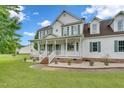 Beautiful home with a cozy front porch, brick accents, and a well-manicured lawn at 31 Bucking Saddle Way, Willow Springs, NC 27592